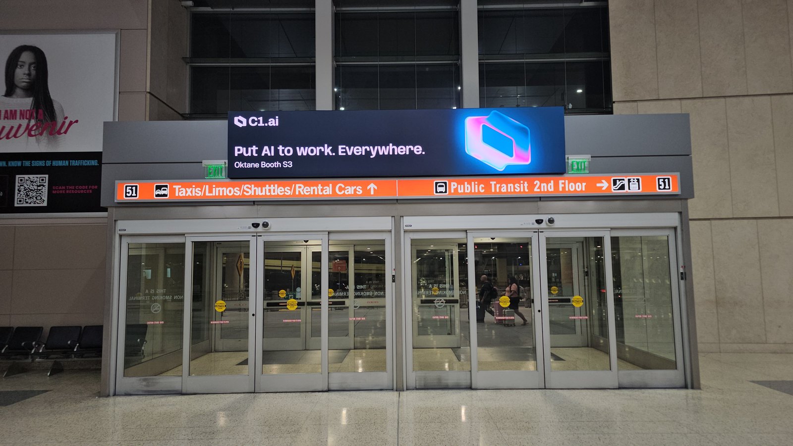C1 airport advertisement above a Harry Reid terminal exit with the message Oktane Booth S3