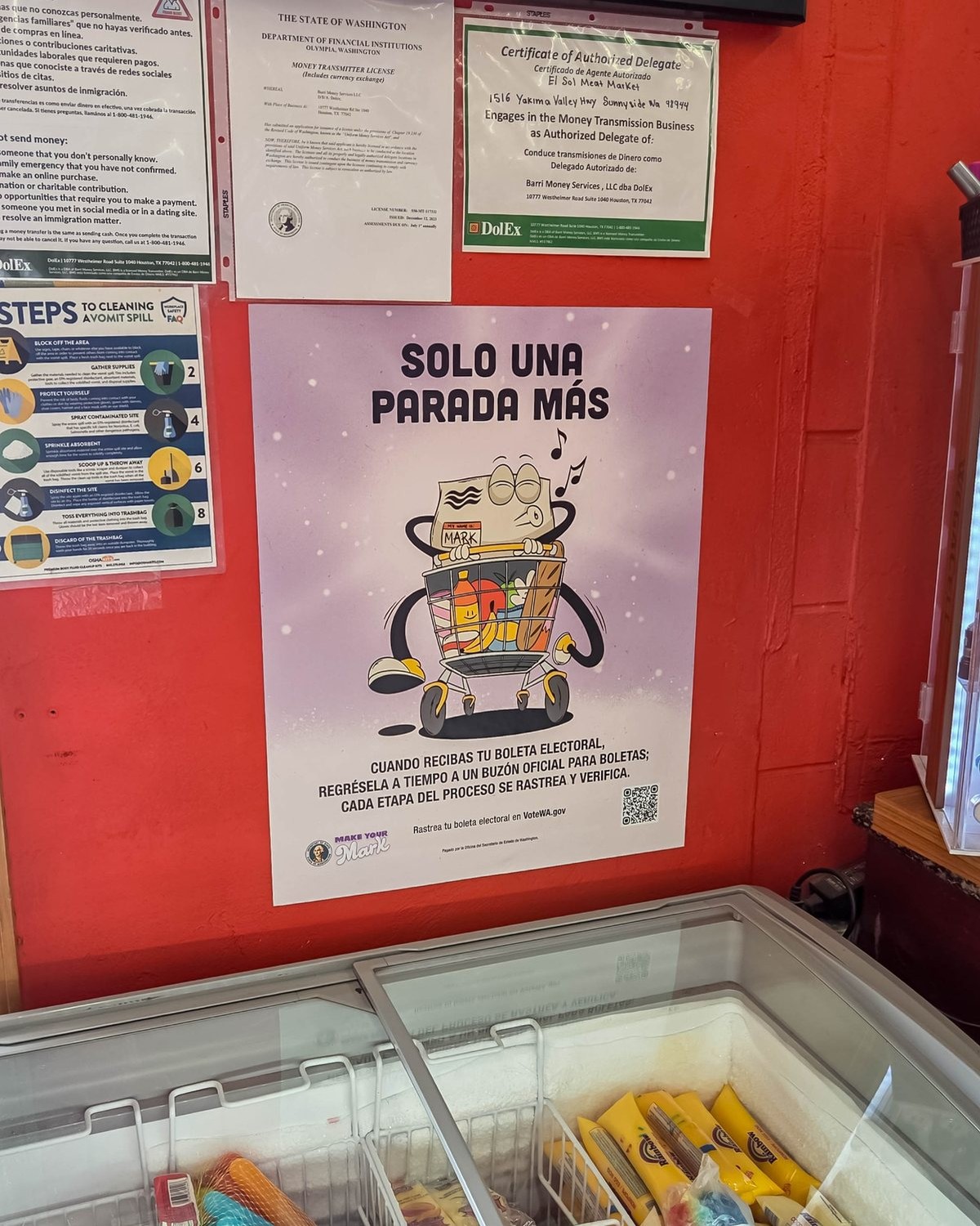 Spanish-language voter outreach poster displayed in a community retail location