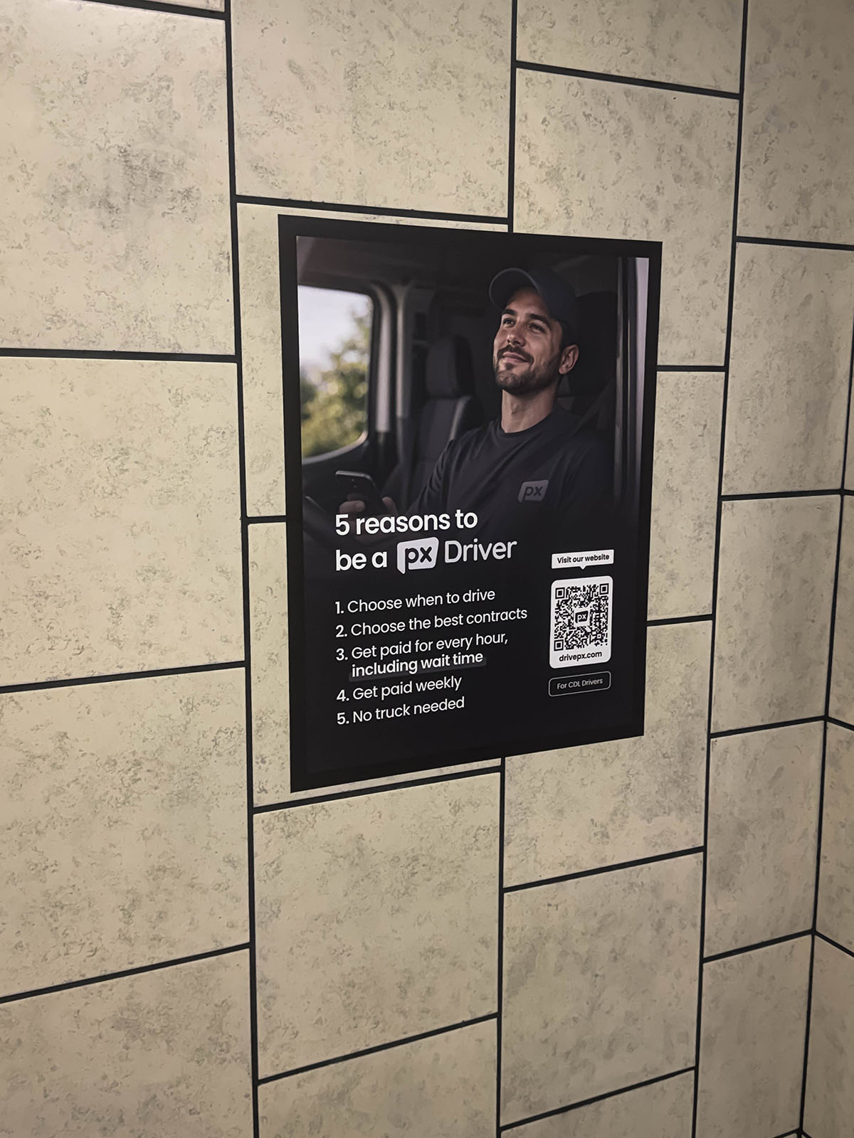 Driver recruitment advertisement displayed inside a truck stop restroom